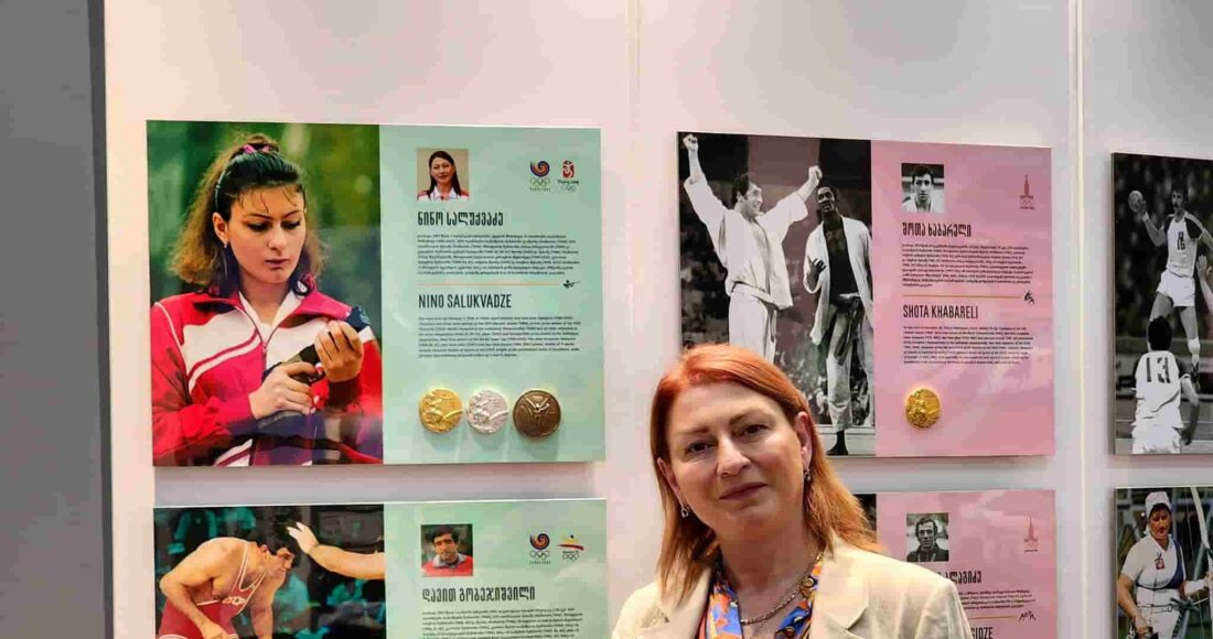Salukvadze là niềm tự hào của thể thao Gruzia. Nữ xạ thủ 55 tuổi đứng cạnh bảng thông tin hình ảnh vinh danh chiến tích của giành trọn bộ HC vàng bắn súng của bà tại bảo tàng Thể thao Gruzia.  Ảnh: Georgia Online