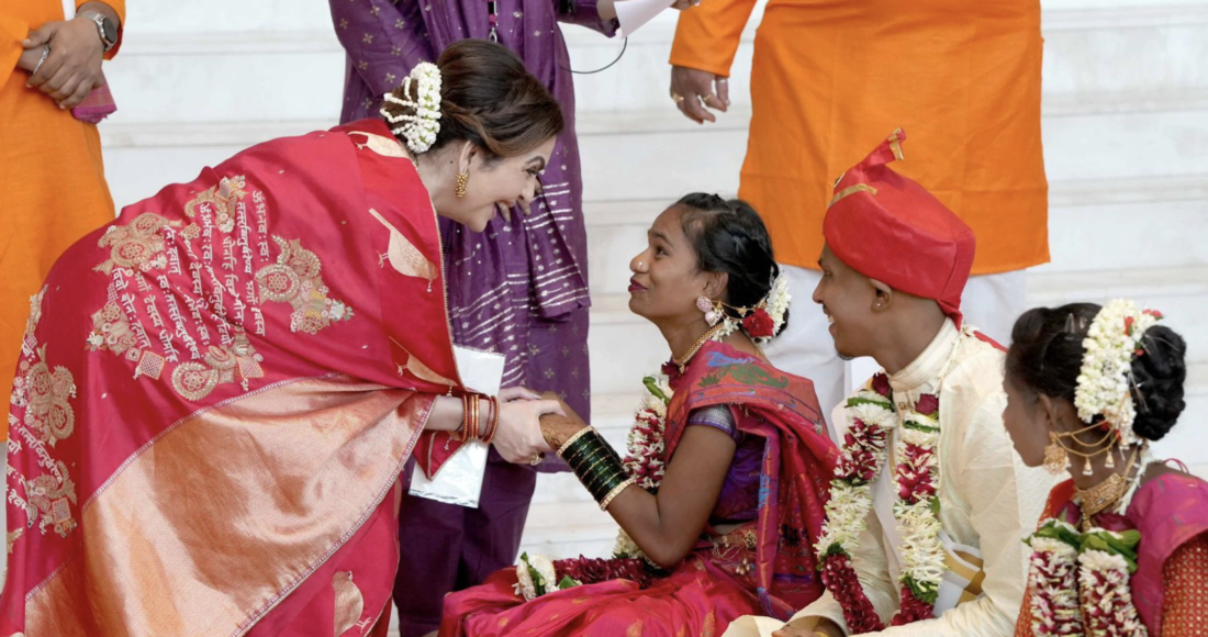 Nhà hoạt động thiện nguyện Nita Ambani (trái), vợ của tỷ phú Mukesh, tặng ngân phiếu cho các cặp đôi ở sự kiện ngày 2/7 tại Maharashtra. Ảnh: IndiaToday