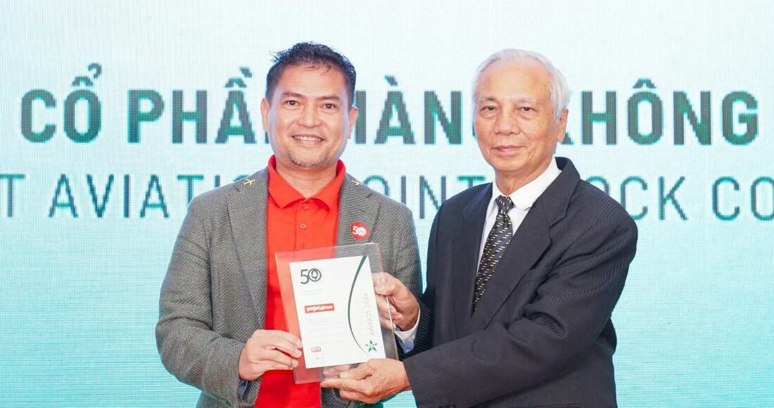 Ông Nguyễn An Di - Giám đốc Nhân sự Vietjet (áo T - shirt đỏ, áo khoác ghi xám) nhận giải thưởng tôn vinh Top 50 doanh nghiệp phát triển bền vững từ ban tổ chức