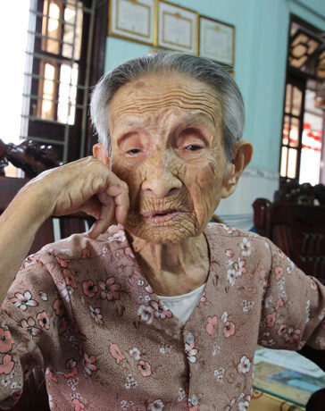 Mẹ Lang rơi nước mắc khi nhắc về con trai liệt sĩ Huỳnh Quang Trợ. Ảnh: Đắc Thành