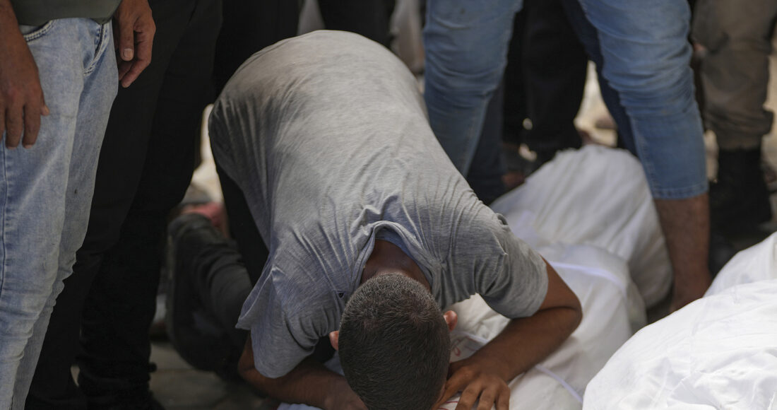 Người Palestine ôm thi thể thân nhân thiệt mạng trong vụ không kích ở miền trung Dải Gaza ngày 17/8. Ảnh: AP