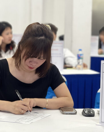 Bà Vân ghi lại thông tin ứng viên tiếng Hàn trong phiên tuyển dụng tại Hà Nội hồi tháng 11. Ảnh: Hồng Chiêu